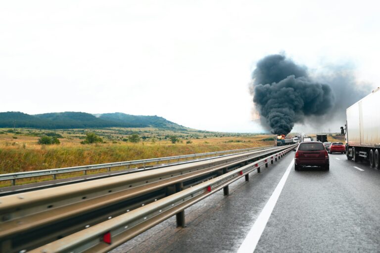 Car crash accident on a highway with damaged automobiles and smoke